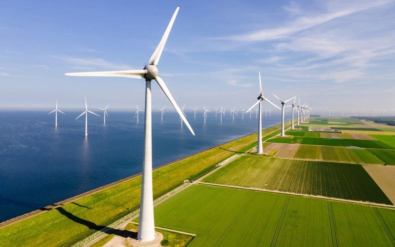 Windmills Turbines And A Blue Sky Generating Electricity Green Energy