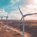 Wind turbines along a section of dirt road