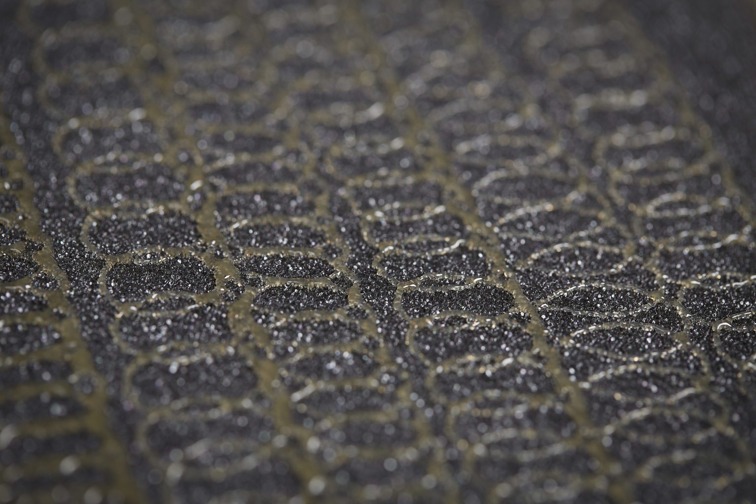 How does the spraytec system work compared to regular spray adhesives